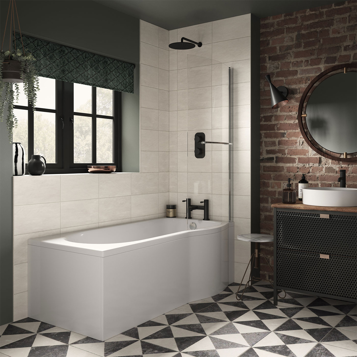 A modern bathroom with a white bathtub, black shower fixtures, and an exposed brick wall. There is a large round mirror and a black vanity cabinet with a white countertop. The floor is tiled with black and white triangles.