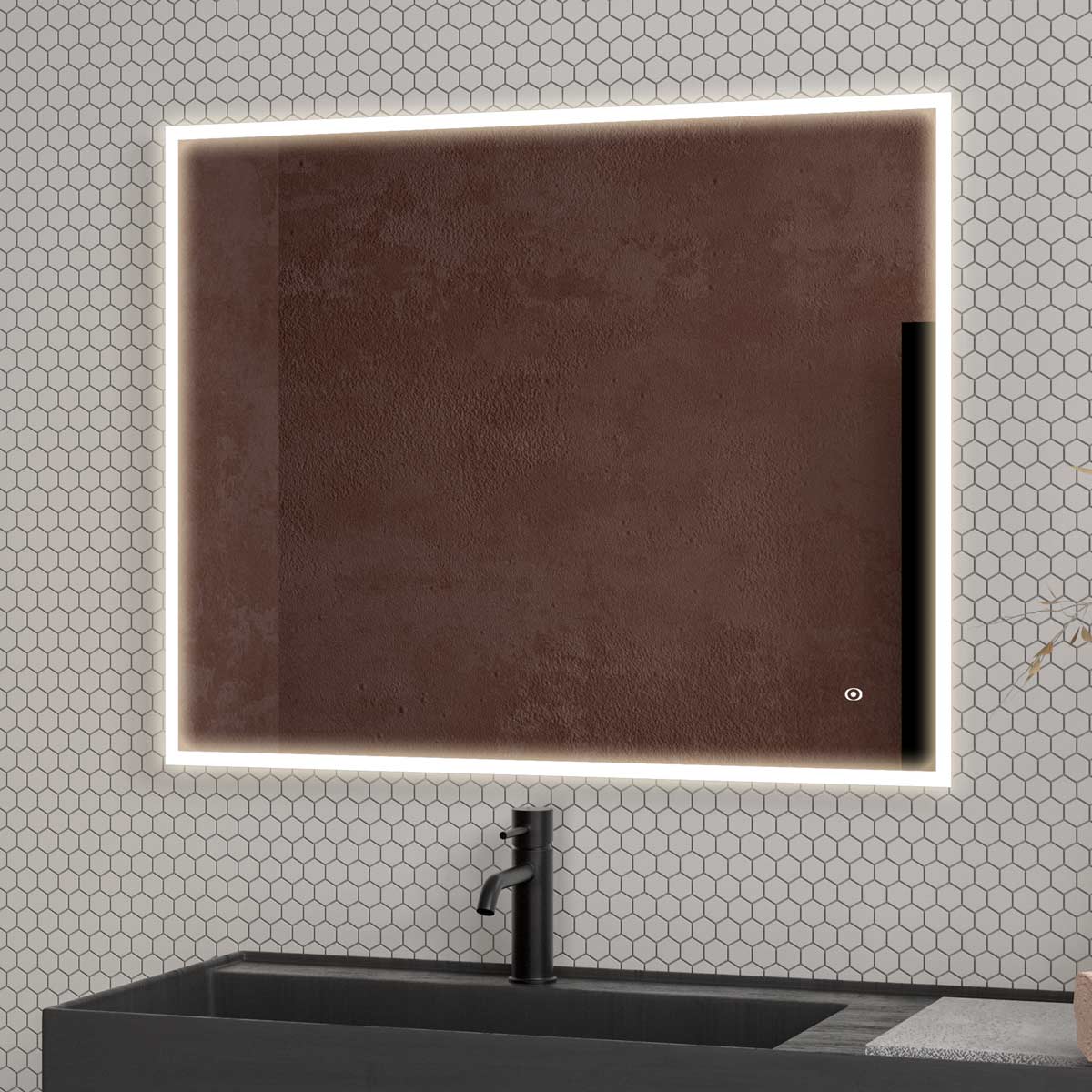 A rectangular mirror with a white LED light frame is mounted on a wall covered in white hexagonal tiles