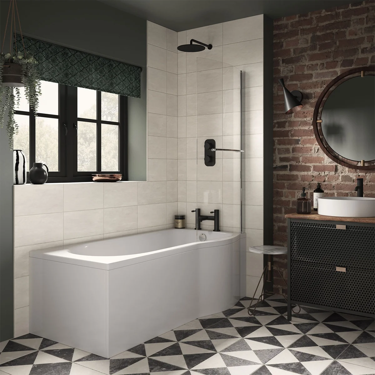 A modern bathroom with a white bathtub, black shower fixtures, and an exposed brick wall. There is a large round mirror and a black vanity cabinet with a white countertop. The floor is tiled with black and white triangles.
