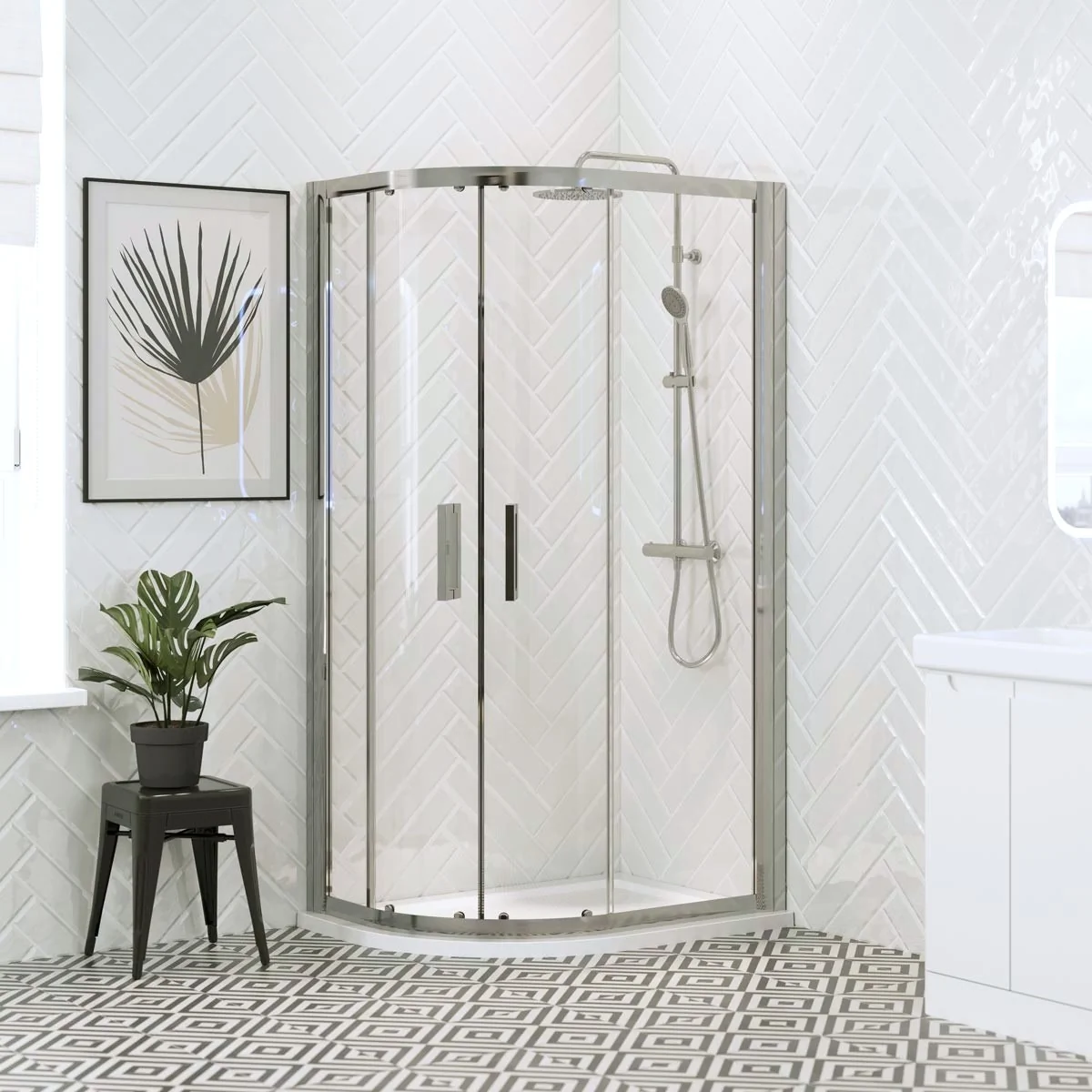 Chrome offset quadrant shower enclosure with sliding glass doors and white shower tray in a bright modern bathroom with white herringbone wall tiles.