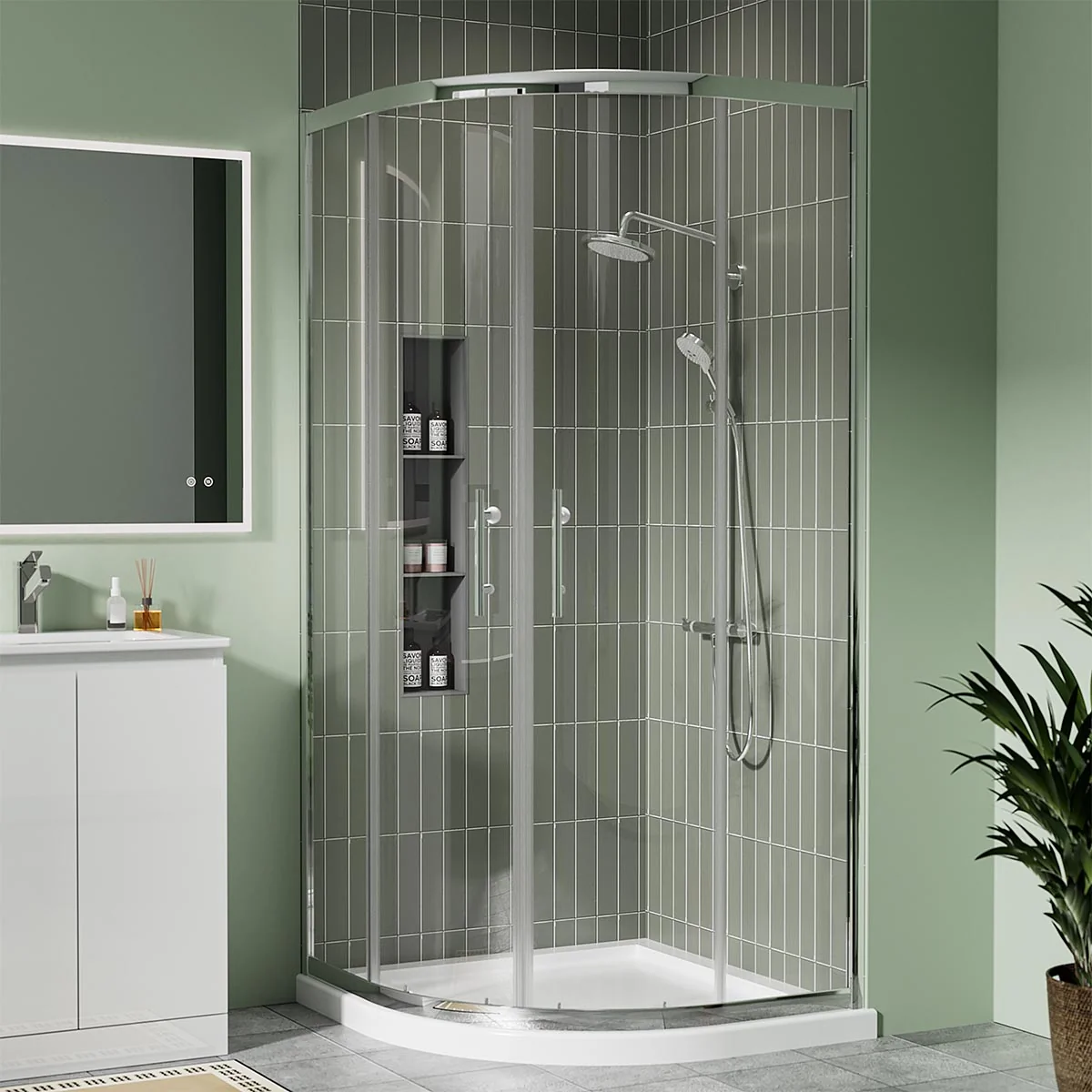 Chrome quadrant shower enclosure with sliding doors and white shower tray in a modern green-tiled bathroom.