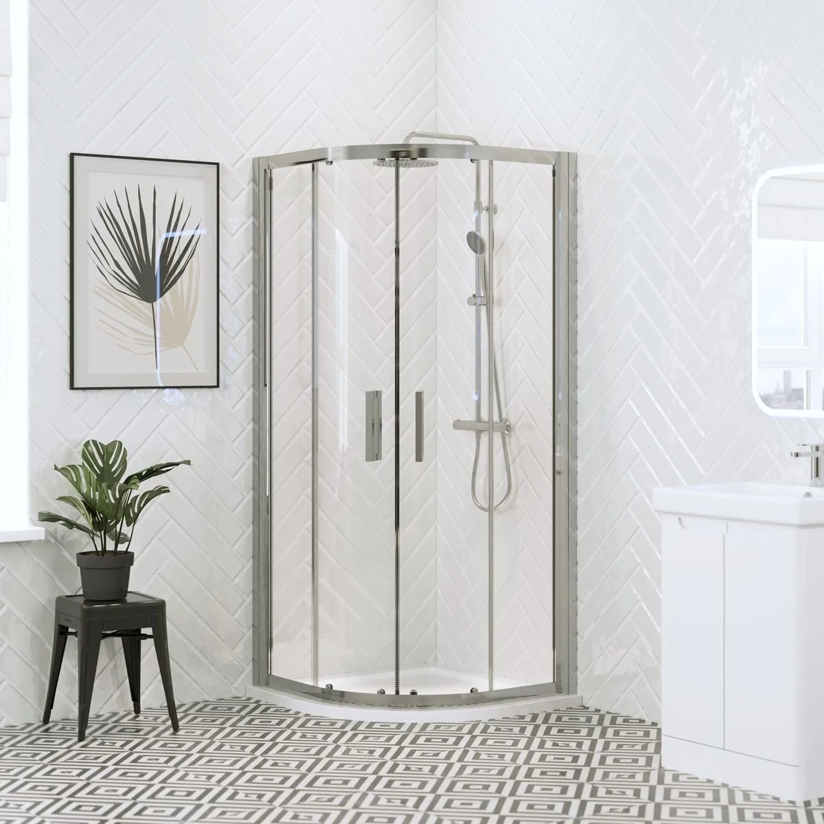 Chrome quadrant shower enclosure with sliding glass doors and white shower tray in a bright modern bathroom with white herringbone wall tiles.