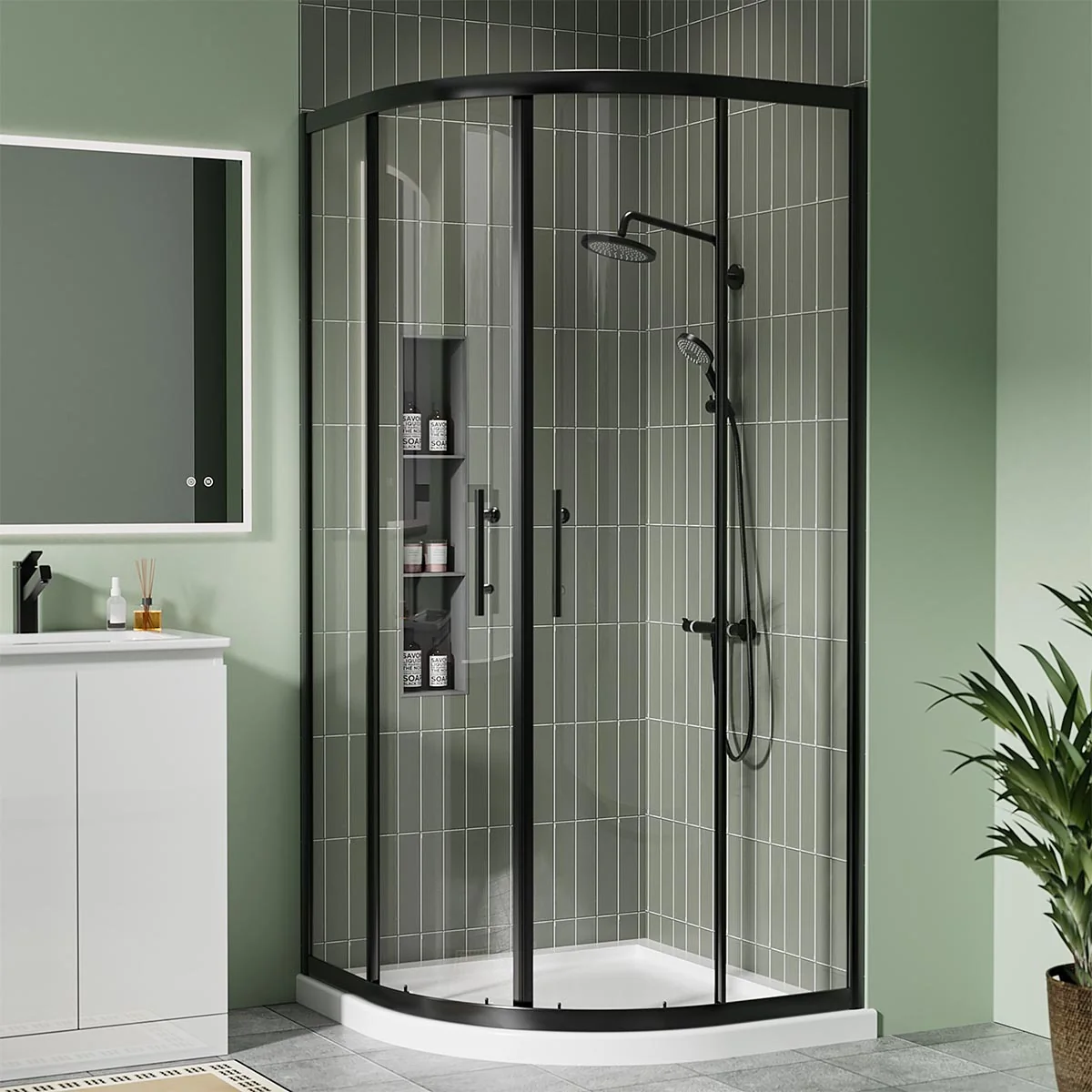 Matt black quadrant shower enclosure with sliding glass doors and white shower tray in a modern green-tiled bathroom.