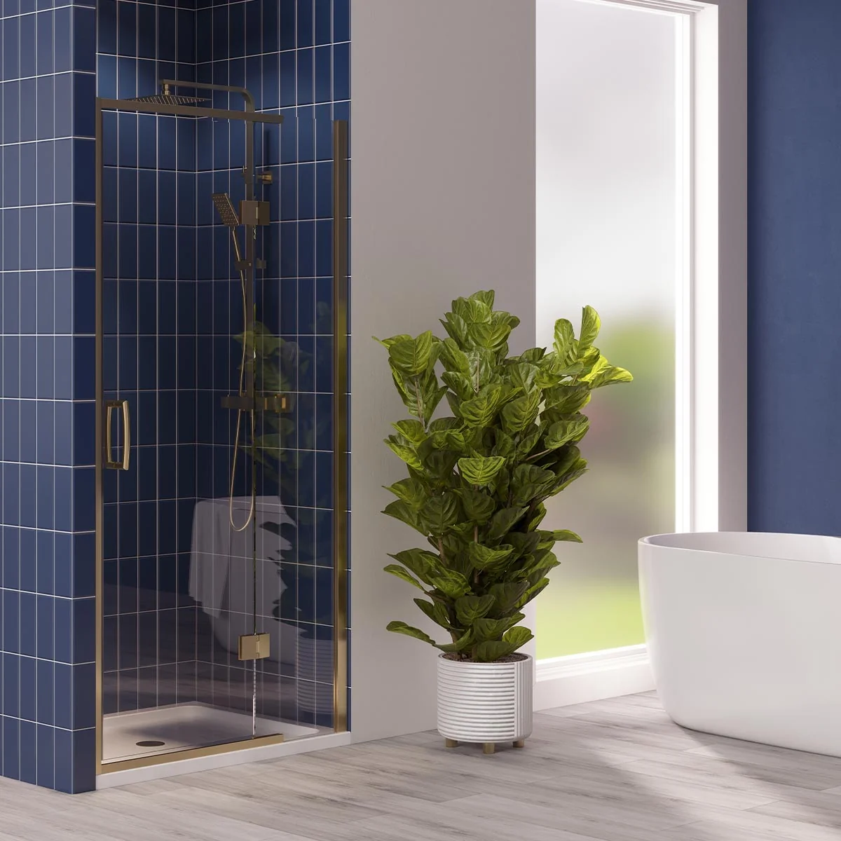 Brushed brass hinged shower door enclosure with clear glass and white shower tray in a modern bathroom with blue tiled walls.
