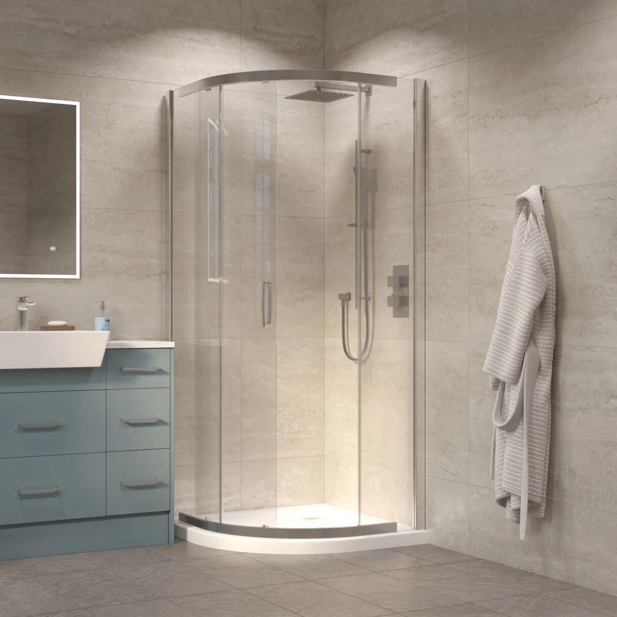 Chrome quadrant shower enclosure with sliding glass doors and white shower tray in a modern beige tiled bathroom