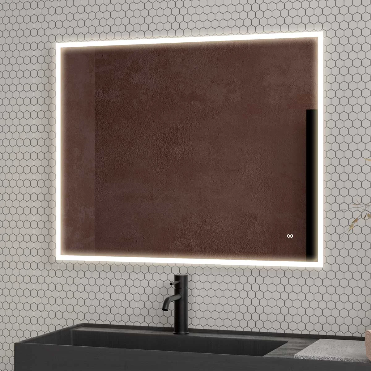 A rectangular mirror with a white LED light frame is mounted on a wall covered in white hexagonal tiles