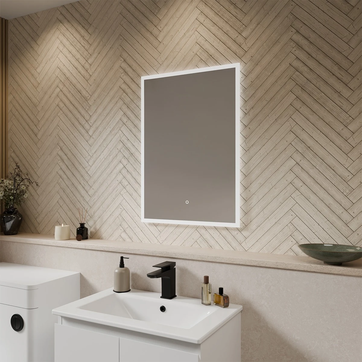 A rectangular mirror with a white LED light frame is mounted on a wall covered in white hexagonal tiles