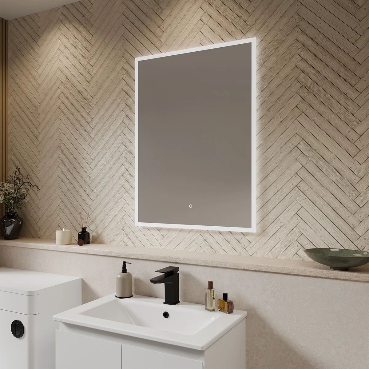A rectangular mirror with a white LED light frame is mounted on a wall covered in white hexagonal tiles