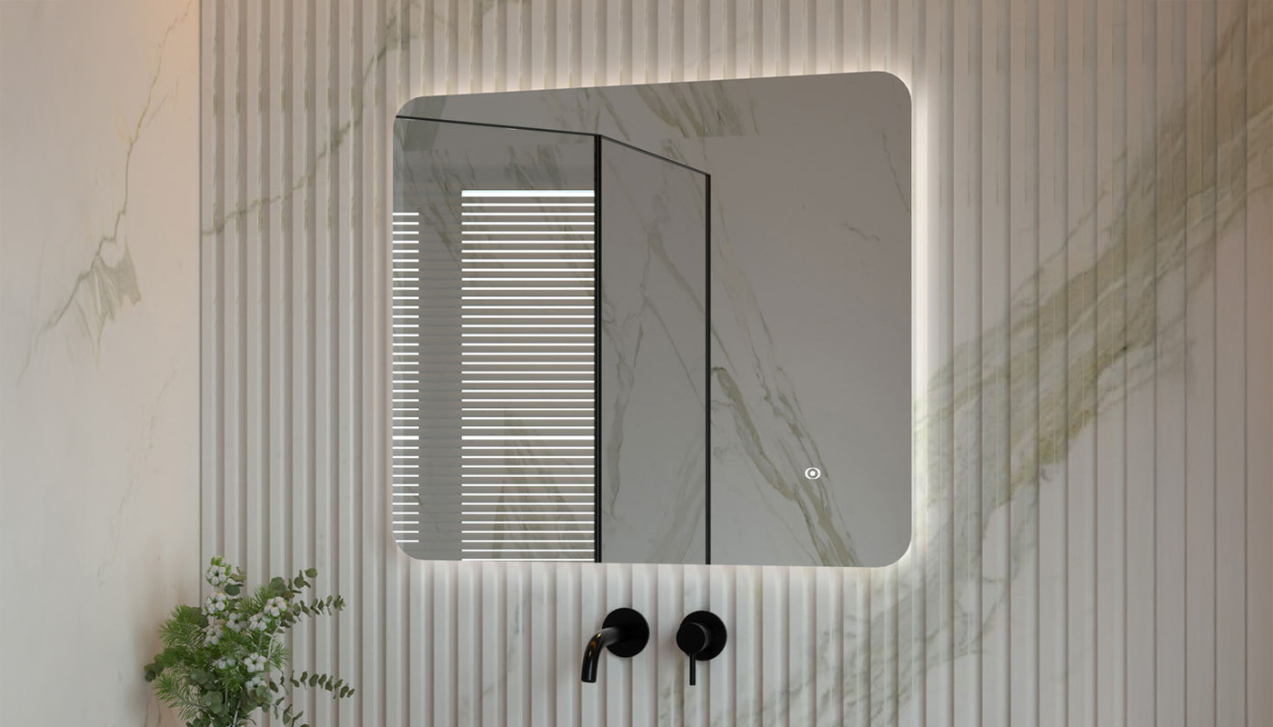 Illuminated rectangular bathroom mirror with rounded corners on a striped wall, above matte black faucet handles.