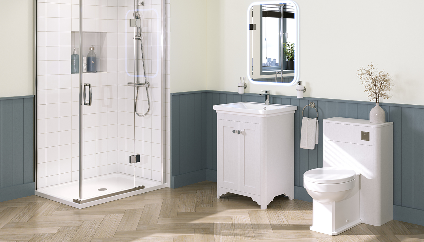 A modern bathroom with white subway tile walls, a walk-in shower with a glass door, a white vanity with a rectangular sink, and a white toilet. The floor is covered in light-colored herringbone wood planks, and there is a large mirror above the sink